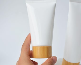 Tubo exprimible de 150 ml y 200 ml con tapa de bambú natural, envase recargable de PET blanco, limpiador facial, tubo exprimible hecho a mano, logotipo personalizado, venta al por mayor