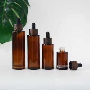 Flacone contagocce in stile 2025, tappo in legno nero naturale, spalla piatta, vetro ambrato trasparente per forniture di imballaggi cosmetici, stile retrò, ordine all'ingrosso