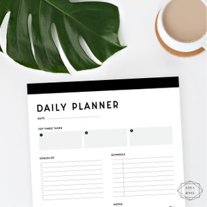 May include: A black and white daily planner with the words "DAILY PLANNER" at the top. The planner has sections for "TOP THREE TASKS", "CHECKLIST", "SCHEDULE", and "NOTES".