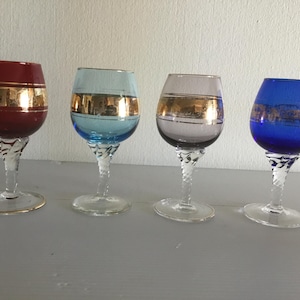 4 small old round digestive glasses on foot