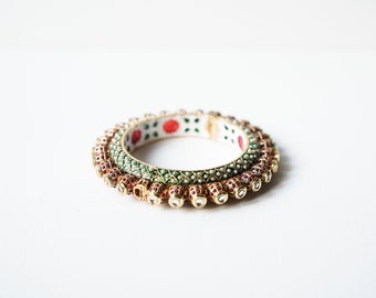 Traditional gold plated bangle with colour enhanced rubies and pearls