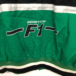 May include: Green and black jacket with a white stripe and the text "BENETTON -F1- "