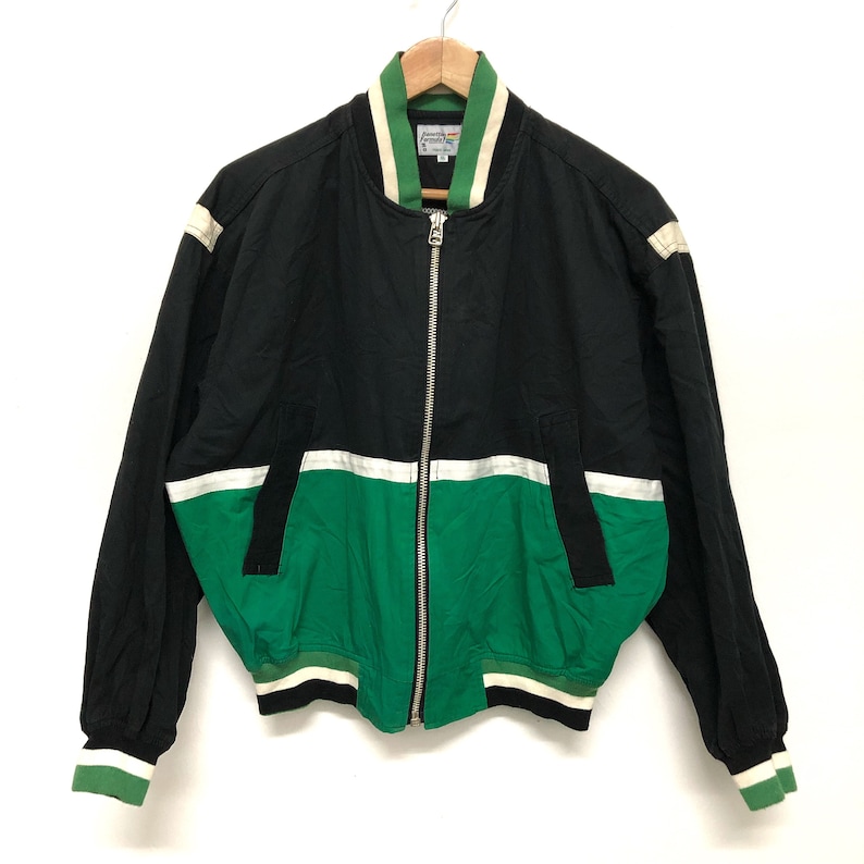 May include: A black and green bomber jacket with a zipper closure. The jacket has white stripes on the sleeves and a white stripe across the chest. The jacket has a green and white striped collar.
