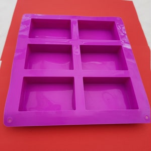 May include: Purple silicone mould with six rectangular cavities for making soap or other crafts.