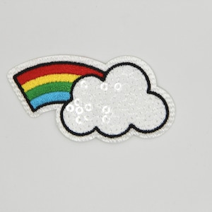 May include: A white cloud with a rainbow coming out of it. The cloud is made of sequins and the rainbow is embroidered.
