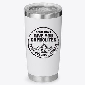 May include: White stainless steel travel mug with a black and white graphic that says "Some days give you coprolite. Some are just schist."