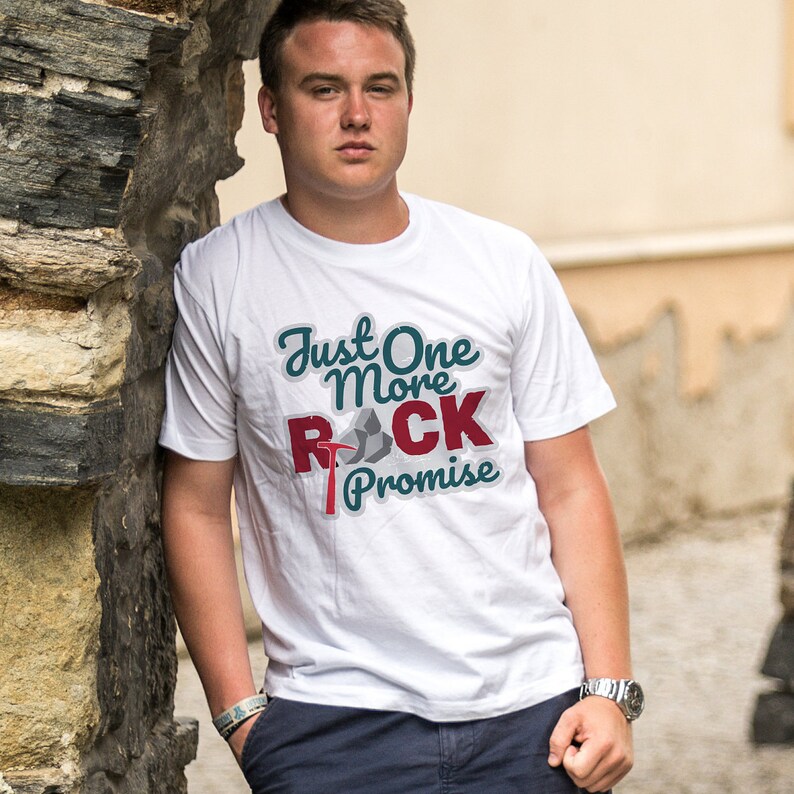 May include: White t-shirt with a graphic design that says "Just One More Rock Promise". The graphic features a pickaxe and rocks.