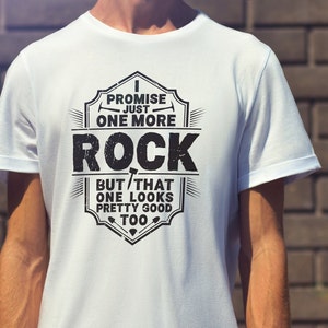 May include: White t-shirt with a black graphic design that says "I promise just one more rock but that one looks pretty good too".