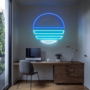 May include: A blue and turquoise neon sign in the shape of a sun with horizontal lines. The sign is mounted on a white wall above a wooden desk with a computer, a lamp, and a plant.