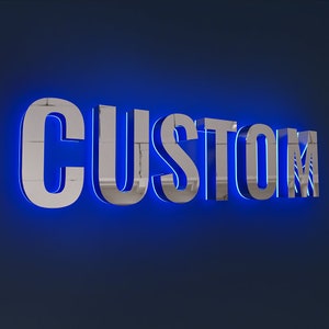 May include: A silver sign with blue neon lights spelling out the word "CUSTOM".