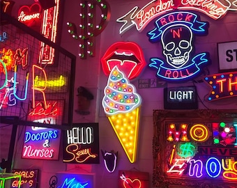 May include: A wall display of various neon signs including a skull with the text Rock N Roll, a red pair of lips above an ice cream cone, a dollar sign, a heart, and text signs reading London Calling, Doctors & Nurses, Hello Sexy, and Max.