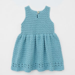 May include: A light blue crocheted dress with a sleeveless design and a gathered skirt. The dress has a button closure at the back.
