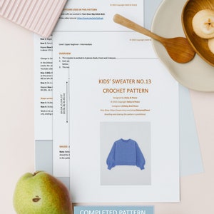 May include: A crochet pattern for a kids' sweater, titled "Kids' Sweater No. 13 Crochet Pattern". The pattern is designed by Daisy & Peace and includes 7 pages. A blue sweater is shown in the image.