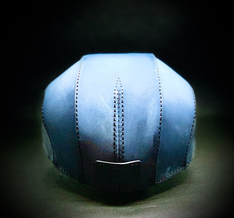May include: A blue denim baseball cap with a stitched seam detail. The cap has a flat brim and a structured crown.