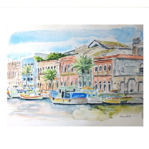 May include: Watercolour painting depicting colourful buildings lining a waterfront with several small boats moored in front of them. The buildings are painted in a variety of colours, including blue, pink, orange, and yellow. The boats are also colourful, with red, blue, yellow, and green accents. The sky is a light blue with some white clouds.