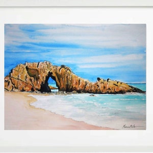 May include: Watercolor painting of a rocky archway on a beach with blue water and a light blue sky. The archway is a natural rock formation with a hole in the middle. The beach is sandy and the water is clear.