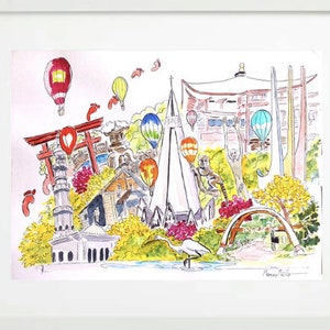 May include: A watercolour painting of a cityscape featuring a mix of buildings, including a church, a pagoda, and a bridge. There are also hot air balloons, monkeys, and a bird in the painting. The painting is framed in white.