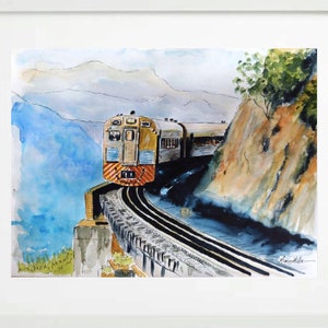 May include: A watercolor painting of a yellow and blue train traveling through a mountain pass. The train is on a track that curves around a bend in the mountain. The mountains are in the background, and the sky is a light blue.