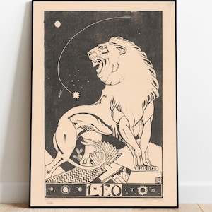 May include: Framed art print featuring a roaring lion illustration in black and beige tones. The artwork includes celestial elements and the word "LEO" at the bottom. The print is displayed on a wooden floor against a white wall.