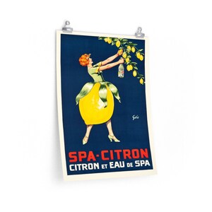 May include: A vintage poster advertising Spa-Citron, a lemon-flavored beverage. The poster features a woman dressed as a lemon, reaching for a bottle of Spa-Citron hanging from a lemon tree. The text on the poster reads "Spa-Citron Citron et Eau de Spa."