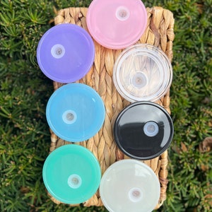 May include: Seven different colored plastic lids for a water bottle. The lids are in a variety of colors, including pink, purple, blue, light blue, green, black, and white.