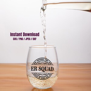 May include: A clear wine glass with a black and white sticker that says "ER SQUAD" with the words "warm, compassionate, caring, loving, dedicated, fun, reliable, loyal, kind" around the outside.  A bottle of wine is being poured into the glass.