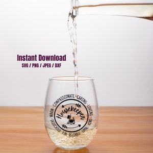 May include: A clear glass wine glass with a black and white design that says "Housekeeper" surrounded by words describing the qualities of a housekeeper. The glass is being filled with a clear liquid.