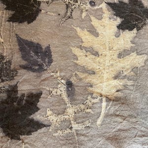 May include: A white ceramic mug with a black handle and the text "But First, Coffee" in a handwritten style. The mug is on a white surface. The mug is approximately 4 inches tall.