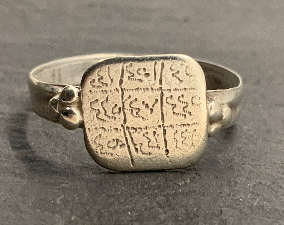 A gold signet ring that bears an expanded cartouche of Queen Nefertiti,  consort to King Akhenaten who reigned circa 1353-1336 BCE under the 18th  Dynasty. The inscription reads 