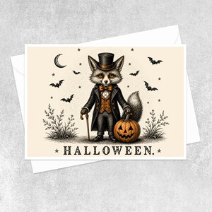 May include: A rectangular greeting card featuring a central illustration of a fox dressed in a black top hat, tailcoat, and orange vest. The fox holds a cane and a carved jack-o'-lantern. The text HALLOWEEN is printed at the bottom center.