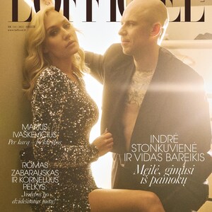 May include: A magazine cover featuring a couple in a romantic pose. The magazine is titled "L'Officiel" and the cover features the text "Marius Iva&scaron;kevičius: Per karą -  įe kar&scaron;ybą" and "Indre Stonkuvienė ir Vidas Bareikis: Meilė, gimusi i&scaron; pamokų".