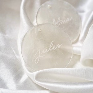 hand-calligraphed mother-of-pearl place markers with pearl / refined mother-of-pearl name holder with white writing