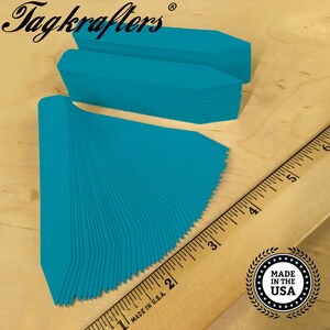 May include: A pack of 50 turquoise plant markers, made in the USA. The markers are 2 inches long and are arranged in a fan shape. The markers are made of a durable plastic and are perfect for labeling plants in your garden.
