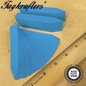 May include: A stack of 100 blue plant markers with pointed ends. The markers are arranged in a fan shape and measure approximately 3 inches in length. The markers are made in the USA.