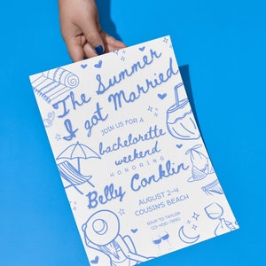 May include: A white invitation with blue ink for a bachelorette weekend. The invitation features a hand-drawn illustration of a beach scene with a coconut drink, beach chairs, and a woman in a swimsuit. The text reads "The Summer I got Married" and "Join us for a bachelorette weekend honoring Belly Conklin". The date is August 2-4 at Cousin's Beach. RSVP information is included.