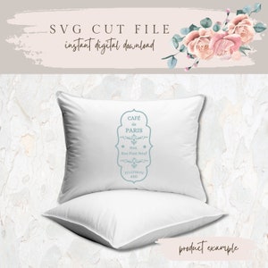 May include: A white pillow with a blue and white graphic that says "Caf&eacute; de Paris" with the address "No9. Rue Pont Neuf" and the phone number "620".