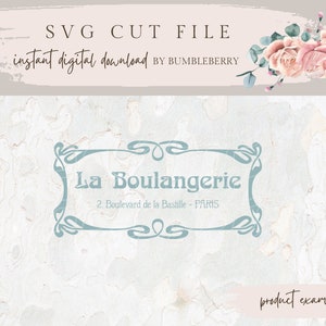 May include: A digital download SVG cut file for a bakery logo with the text "La Boulangerie" and the address "2. Boulevard de la Bastille - PARIS". The logo is in a light blue color and has a decorative, ornate frame. The background is a light beige with a textured pattern.