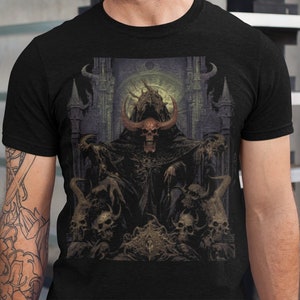 May include: Black t-shirt featuring a graphic print of a horned, hooded figure seated on a throne surrounded by skulls.