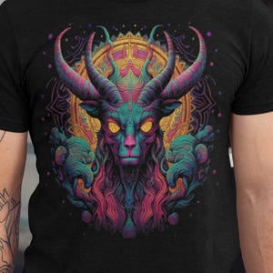 May include: A black t-shirt with a colorful graphic of a horned creature with glowing eyes. The creature is surrounded by a mandala-like design with intricate details.