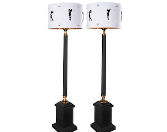Gold and black table lamp with lampshade.