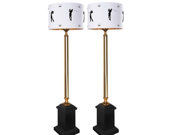 Gold and black table lamp with lampshade.