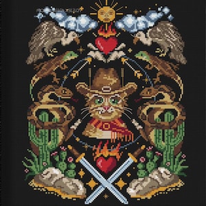 May include: Cross-stitch art in a black frame. The artwork features a cat wearing a cowboy hat and bandana, surrounded by desert-themed elements like cacti, snakes, and eagles. The design includes hearts, swords, and the text "mama with xstitch".