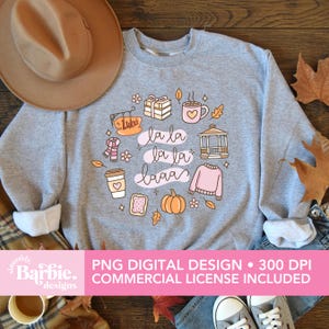 May include: A light gray sweatshirt with a circular graphic featuring fall-themed illustrations and the phrase "la la laaa." The design includes a coffee cup, pumpkin, sweater, and other autumn elements. The text "PNG DIGITAL DESIGN &bull; 300 DPI COMMERCIAL LICENSE INCLUDED" is also present.