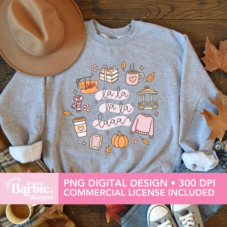May include: A light gray sweatshirt with a circular graphic featuring fall-themed illustrations and the phrase "la la laaa." The design includes a coffee cup, pumpkin, sweater, and other autumn elements. The text "PNG DIGITAL DESIGN &bull; 300 DPI COMMERCIAL LICENSE INCLUDED" is also present.