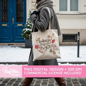 May include: A cream-colored tote bag with the phrase "Baking Spirits Bright" and baking-themed illustrations. The bag features a rolling pin, mixer, gingerbread man, and other festive designs. The bag is carried by a person wearing a gray coat.