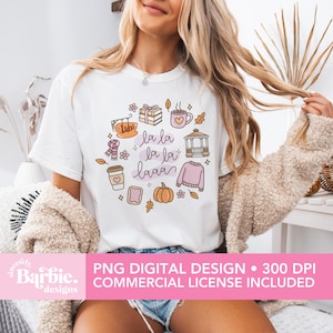 May include: White t-shirt featuring a colorful autumn-themed graphic with the text "la la la la la laaa". The design includes illustrations of a coffee cup, sweater, pumpkin, and other fall elements. The bottom of the image includes the text "PNG DIGITAL DESIGN &bull; 300 DPI COMMERCIAL LICENSE INCLUDED".