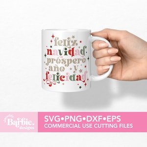 May include: White ceramic mug with a festive design featuring the Spanish text "Feliz Navidad, Prospero A&ntilde;o y Felicidad" in red, green, pink, and brown lettering with white stars.