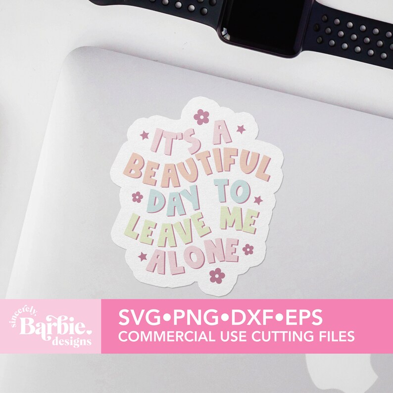 May include: A pink and white sticker with the text "It's a beautiful day to leave me alone" in a colorful font. The sticker has a flower design and is on a white laptop.