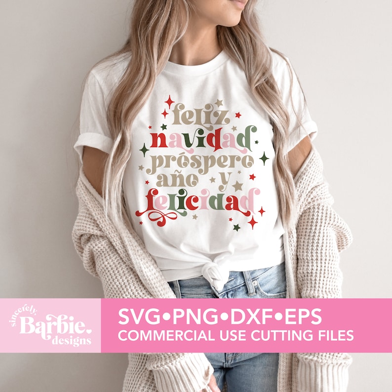 May include: White t-shirt with a festive design that says "feliz navidad prospero a&ntilde;o y felicidad" in a colorful, retro font. The design is surrounded by red and green stars.