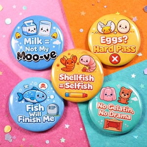 May include: Five circular pin-back buttons featuring cartoon illustrations and text. One blue button says Milk = Not My Moo-ve, a yellow one says Eggs? Hard Pass, an orange one says Shellfish = Selfish, a blue one says Fish Will Finish Me, and a teal one says No Gelatin, No Drama.
